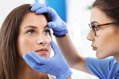 Doctor examining woman's eye.